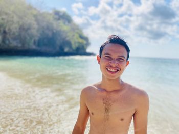 Portrait of smiling young man on beach