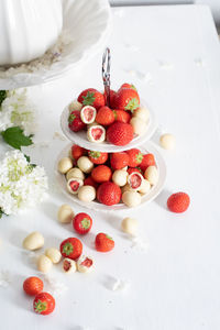 White chocolate covered strawberries, fresh strawberries and white floweers