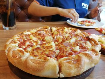 Close-up of pizza served on table in restaurant