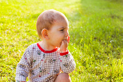 Cute girl slitting on grass at park