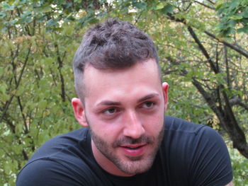 Portrait of smiling man against plants