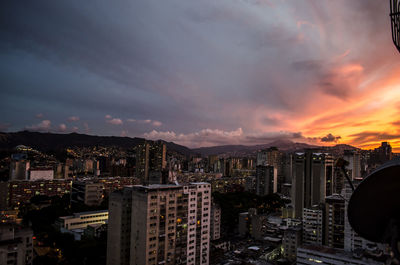 High angle view of illuminated buildings against sky during sunset