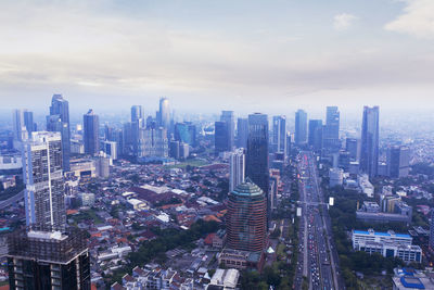 High angle view of modern buildings in city against sky