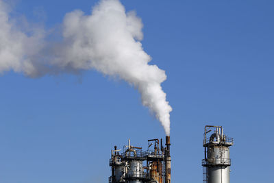 Low angle view of smoke stack against sky