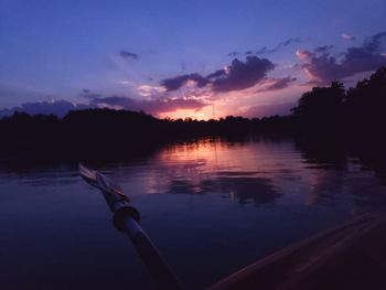 Scenic view of lake against sky at sunset