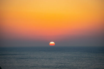 Scenic view of sea against romantic sky at sunrise 