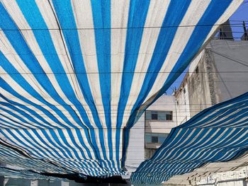 Low angle view of striped fabric on ropes