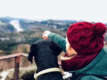 Woman with dog against landscape