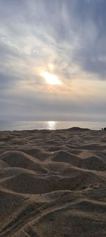 Scenic view of beach against sky during sunset