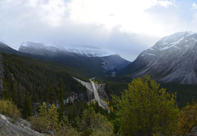 Scenic view of mountains against cloudy sky