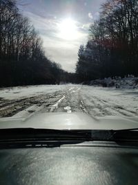 Surface level of snow covered landscape against sky