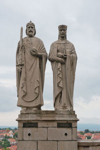 Low angle view of statue against cloudy sky