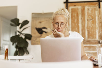 Woman using laptop at home