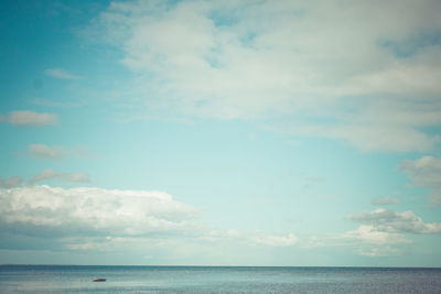 Scenic view of calm sea against cloudy sky