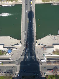 High angle view of cars on city by sea