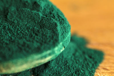 Close-up of green paint on table