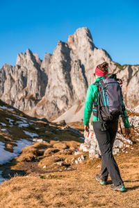 Rear view of man walking on rock