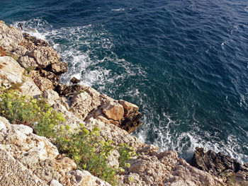 High angle view of rocks in sea