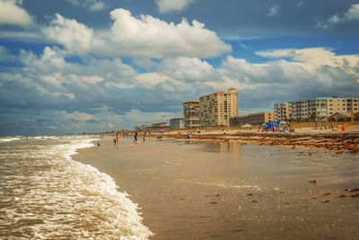 View of beach with city in background