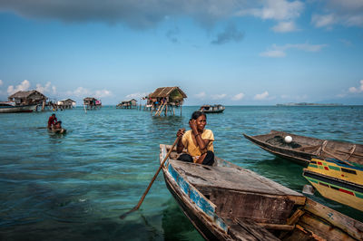 Panoramic view of man standing on sea against sky