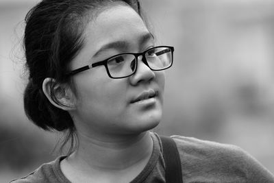 Black and white portrait of a natural look of a young girl wearing a glasses 
