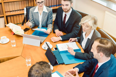 High angle view of people working on table