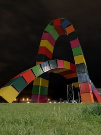 Low angle view of multi colored umbrella on field