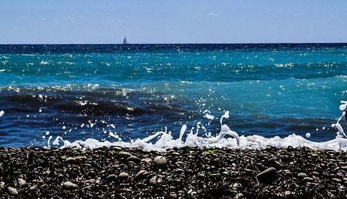 Scenic view of sea against blue sky