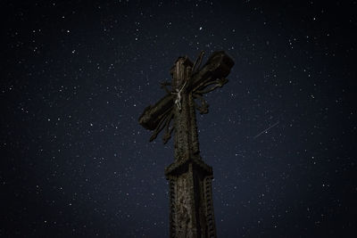 Low angle view of statue against sky at night