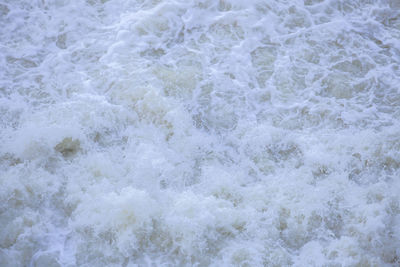 High angle view of waves rushing towards shore