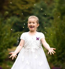 Happy girl playing with confetti