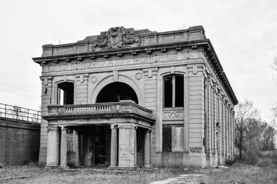 Exterior of old historic building on field against clear sky