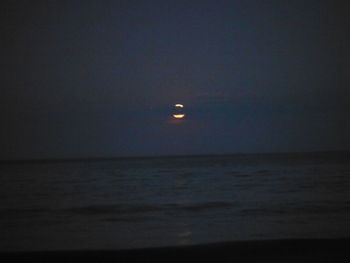 Scenic view of sea against clear sky at night