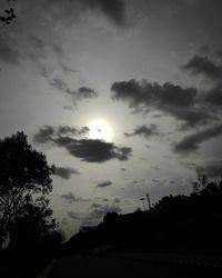 Low angle view of silhouette trees against sky