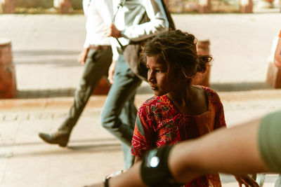 Low section of people walking on street