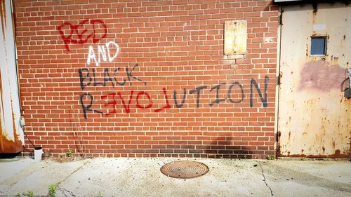Graffiti text on brick wall