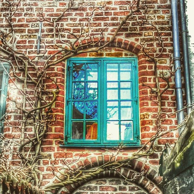 window, building exterior, architecture, built structure, brick wall, house, glass - material, closed, door, residential structure, residential building, building, reflection, day, wall - building feature, no people, outdoors, low angle view, old, safety