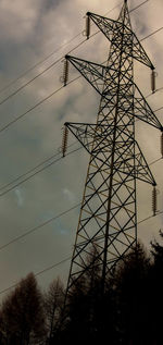 Low angle view of electricity pylon against sky