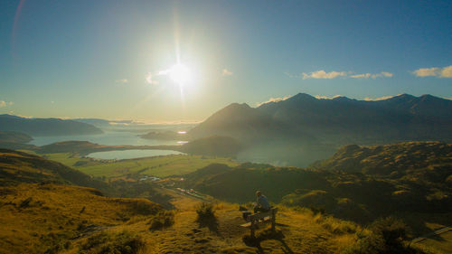 Scenic view of mountains against bright sun