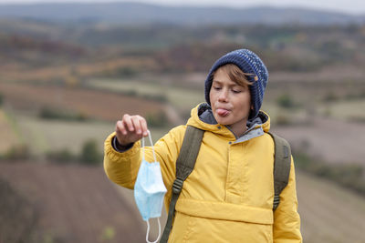 Happy boy standing in park during winter