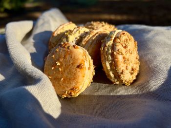 Orange pumpkin flavor macaron sandwich cookies with cream filling in warm sunlight 