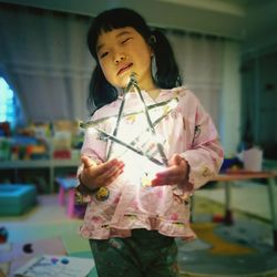 Close-up of a girl holding camera