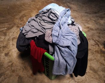 Pile of clothes in basket on floor