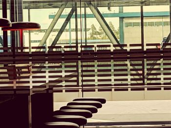 Close-up of chairs on table by building