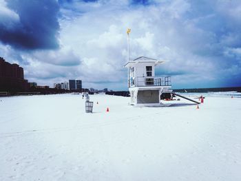 Lifeguard hut on beach against sky