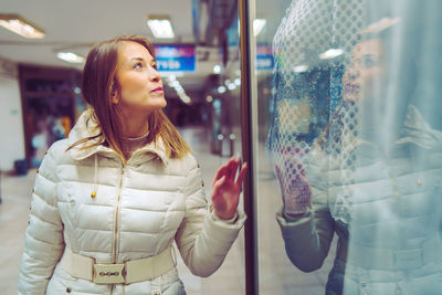 Beautiful woman looking retail display of store