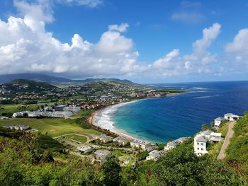 High angle view of town by sea against sky