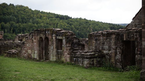 Old ruin on field against sky