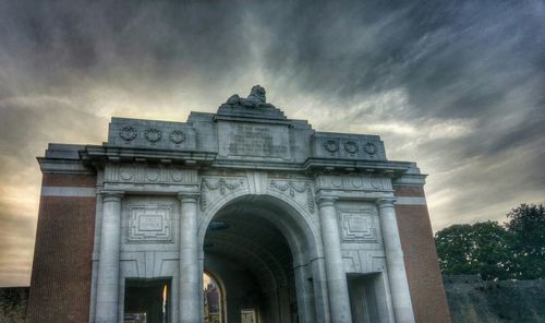 Low angle view of historical building against cloudy sky