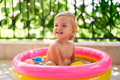 Portrait of smiling boy in swimming pool